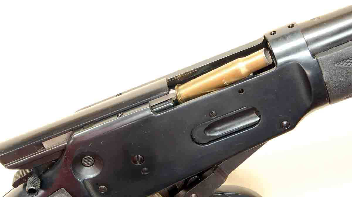 A .30-30 Winchester case ejecting sideways from a Winchester Model 1894 Angle Eject rifle, instead of straight up as in all previous Model 1894s. This allows for standard scope mounting.